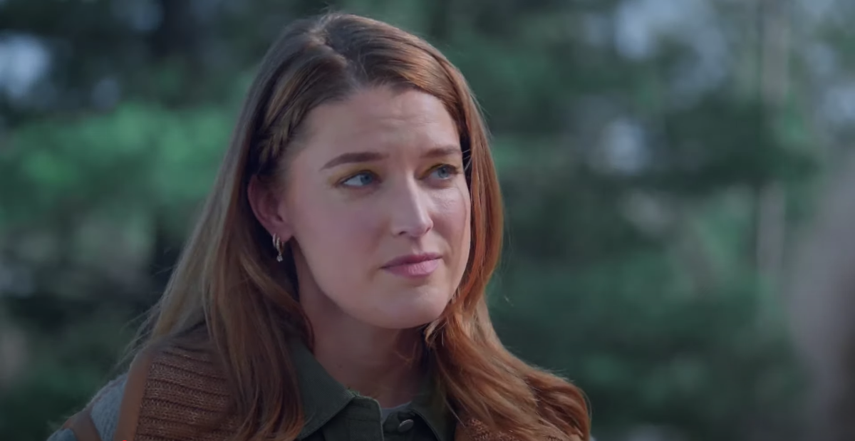 Felicity's face is closely cropped with eyes gazing to the left and a look of slight consternation.